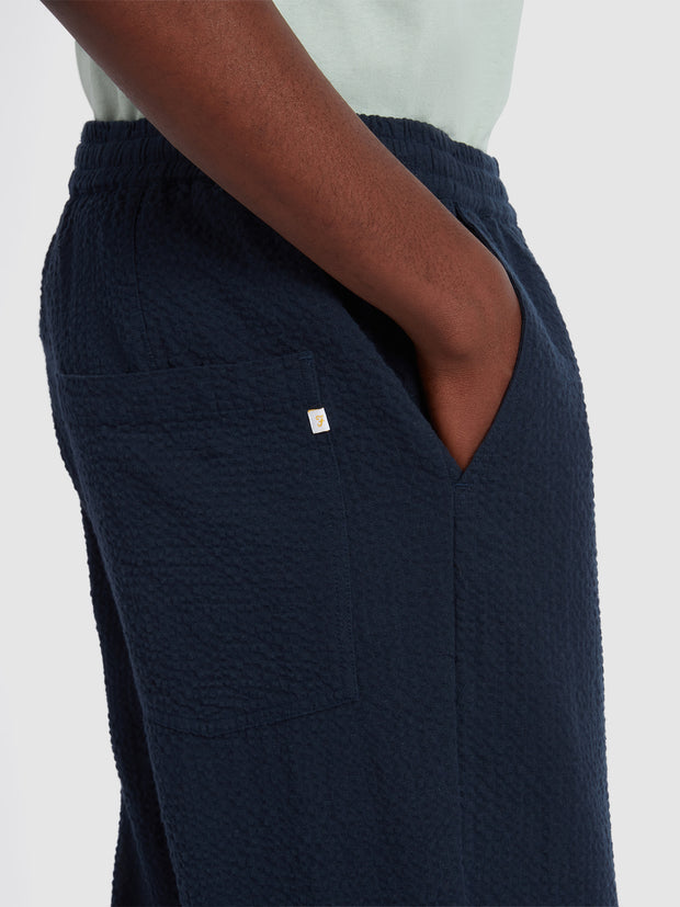 Hawtin Relaxed Tapered Fit Seersucker Trousers In True Navy